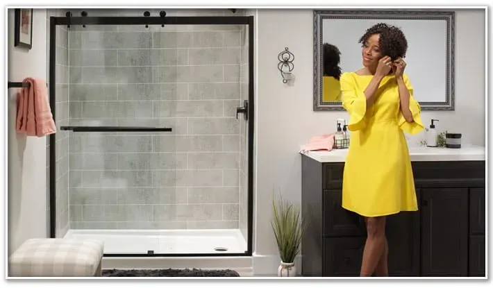 Woman standing next to shower